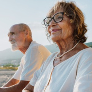 Elderly couple standing watching the sunrise