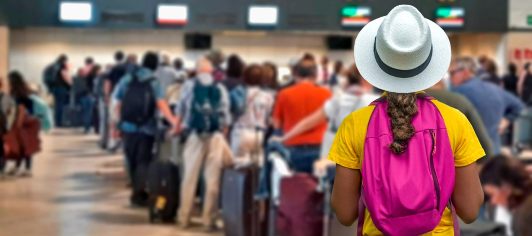 Tourist girl waiting in long lines to check in baggage at crowded airport counters
