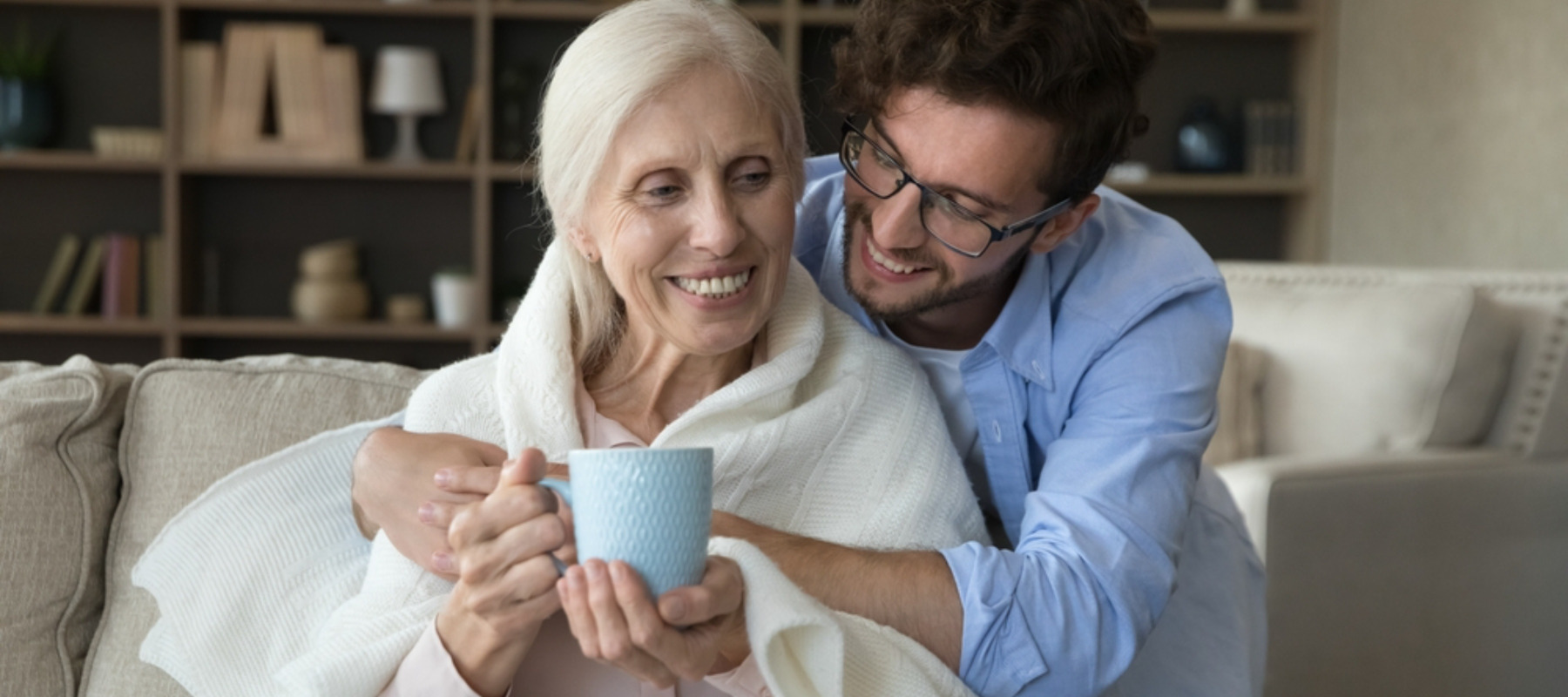 Young man showing affection to elder relative