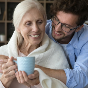 Young man showing affection to elder relative