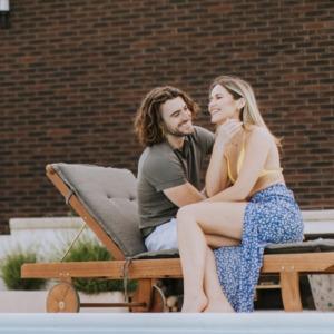 Young couple relaxing in their backyard by the pool