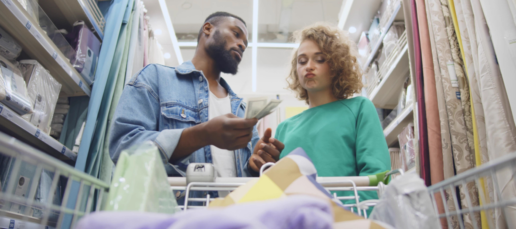 Couple is shopping and arguing about cost