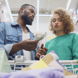 Couple is shopping and arguing about cost