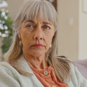 Older woman on the couch with her spouse looking concerned