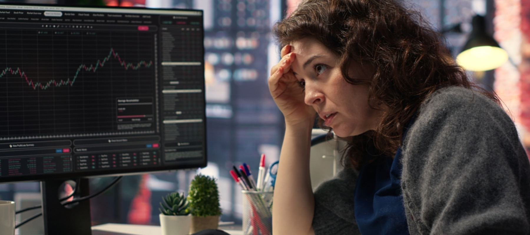 Day trader feeling worried and stressed looking at monetary losses, analyzing stock price trends