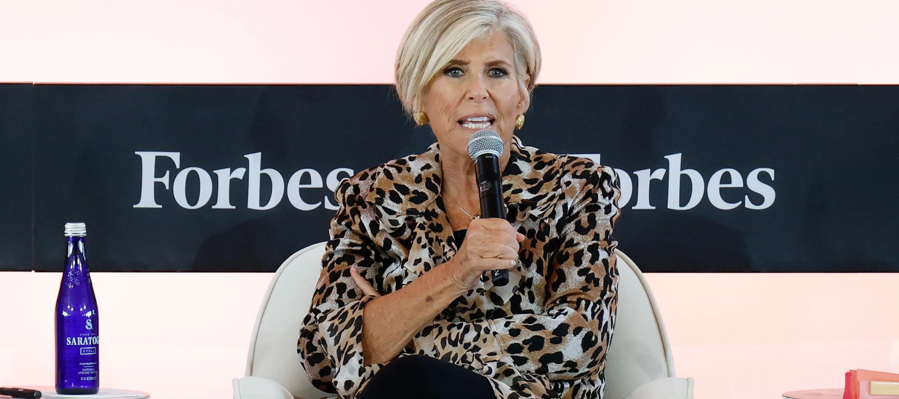 Suze Orman speaking at a conference