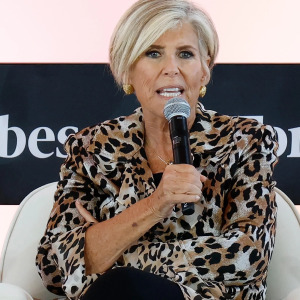 Suze Orman speaking at a conference