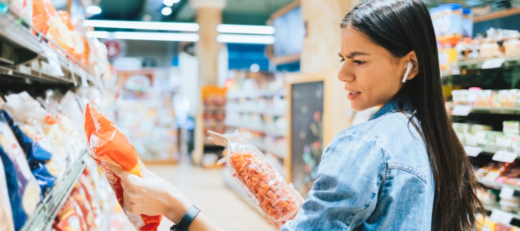 Young woman examines food at a grocery store