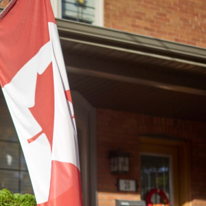 Toronto Ontario, Canada- October 21st, 2022: the front exterior of a house with a Canadian flag on it.