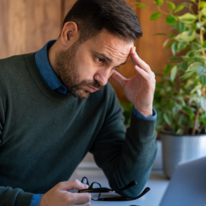 Stressed investor analyzing stock exchange market