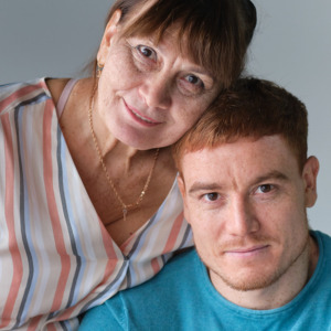 Mother and her adult son embracing each other