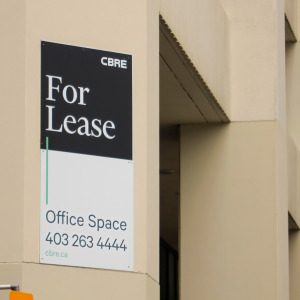 For Lease office space sign in Calgary + Rent here sign apartment complex