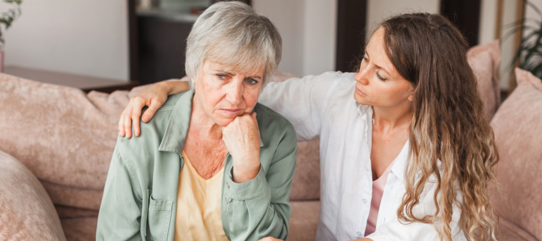 Loving adult daughter talking to sad mother