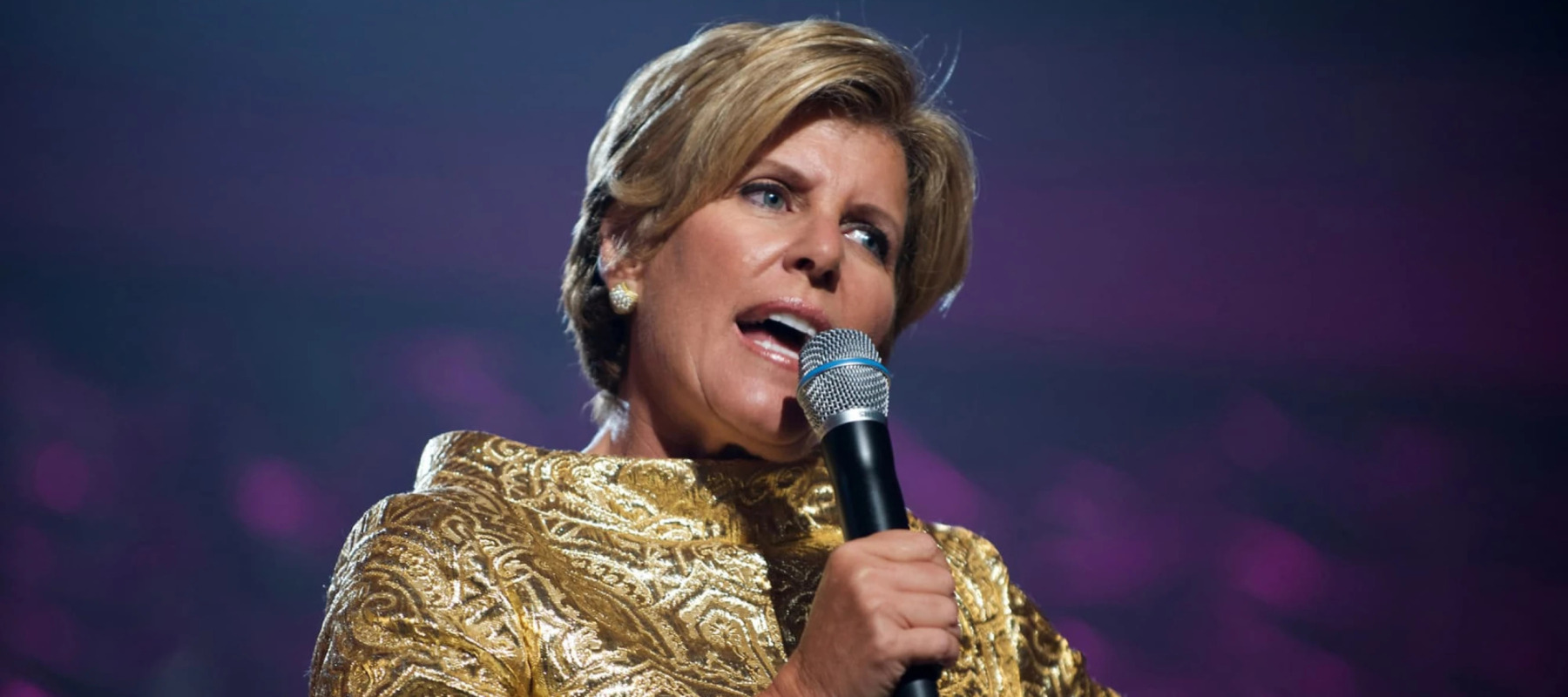 Suze Orman speaking at an event