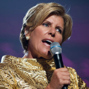 Suze Orman speaking at an event