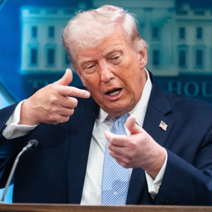 President Donald Trump mimics firing a gun during a news conference in the White House briefing room
