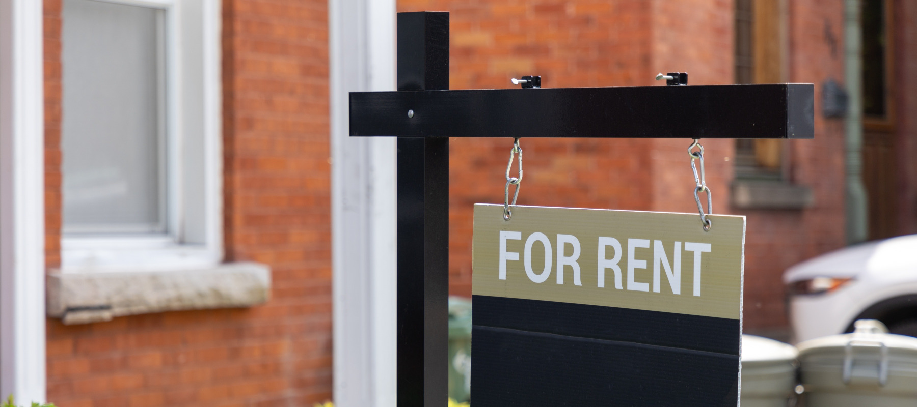 For Rent sign in front of a residential building