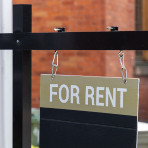 For Rent sign in front of a residential building