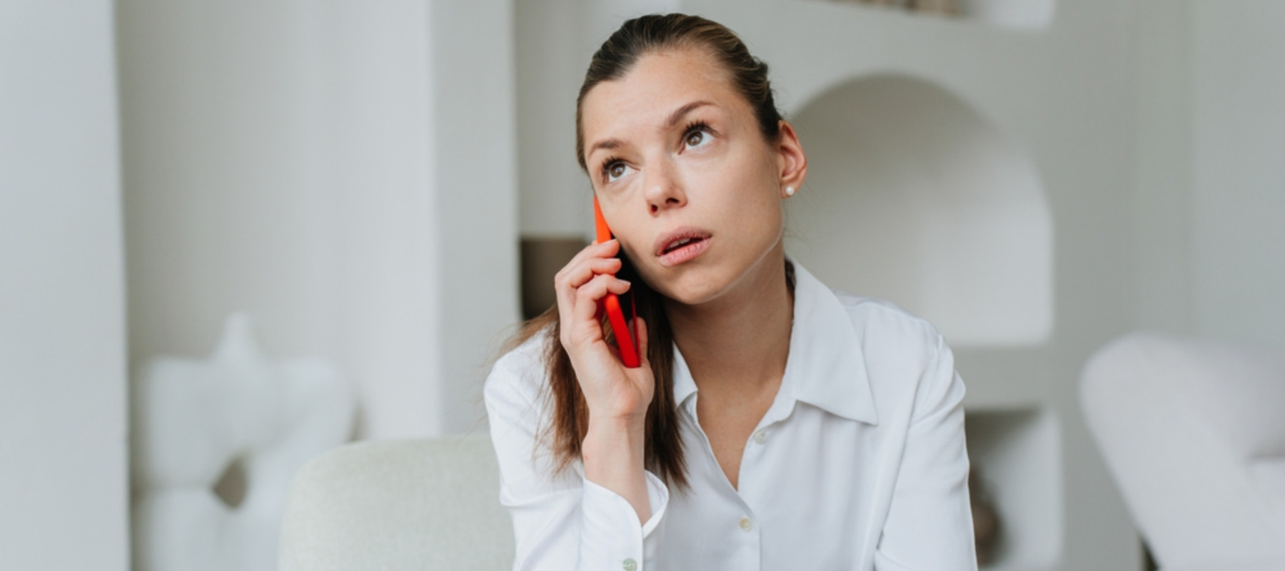 Young brunette woman on phone looking worried