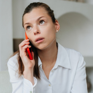 Young brunette woman on phone looking worried