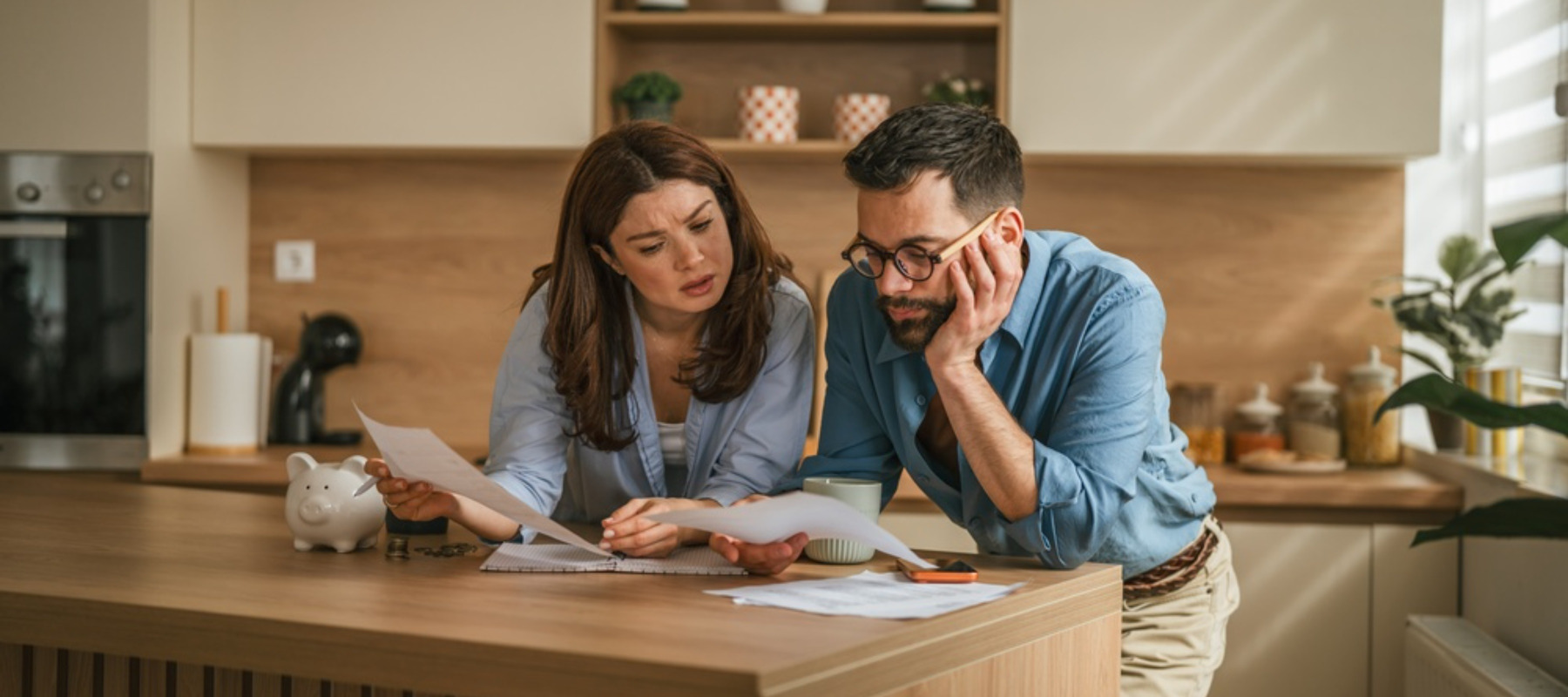 Young couple reviewing finances looking stressed