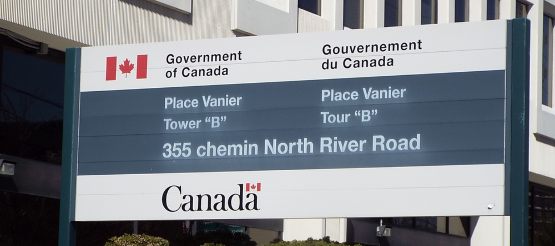 A bilingual (English and French) Government of Canada sign for Place Vanier