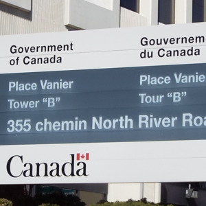 A bilingual (English and French) Government of Canada sign for Place Vanier