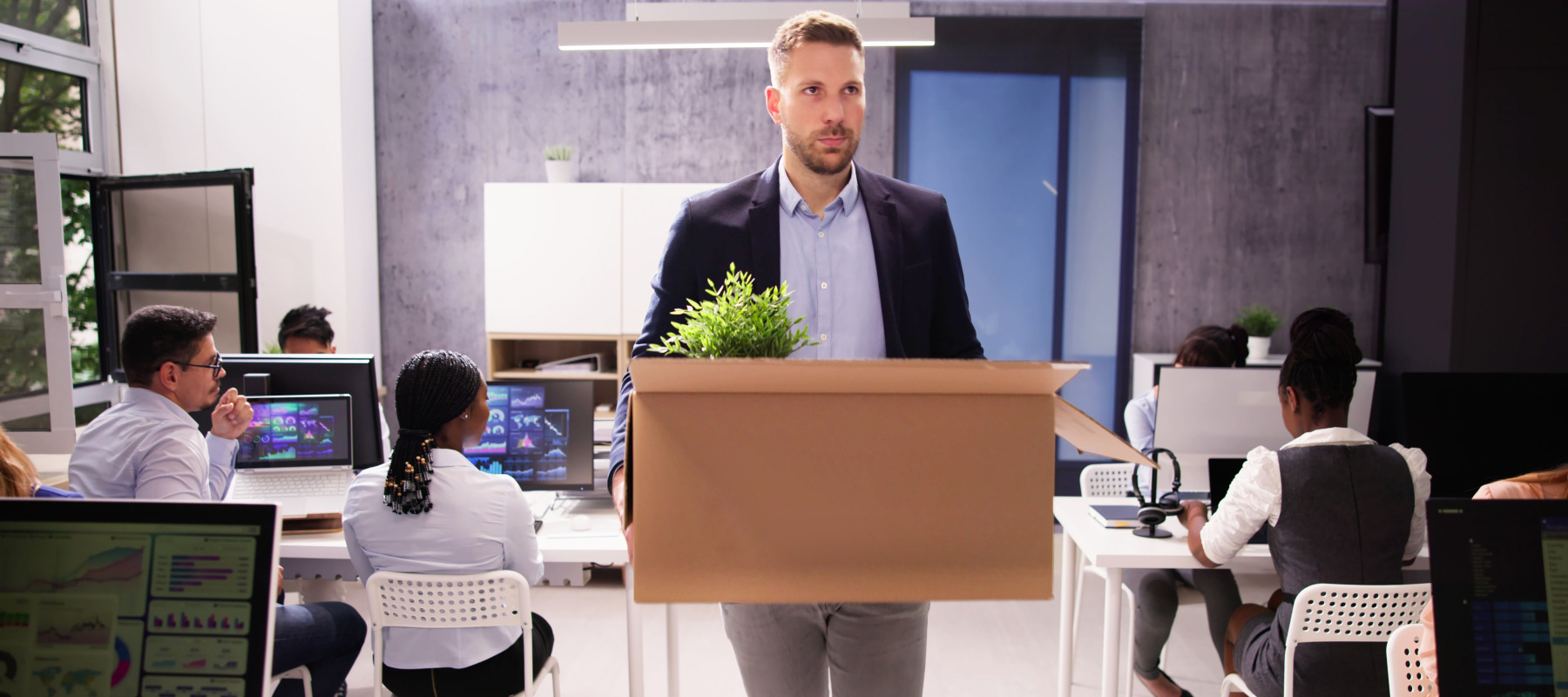 Employee losing his job and packing up his desk and leaving