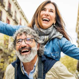 Happy senior couple having fun walking on city street
