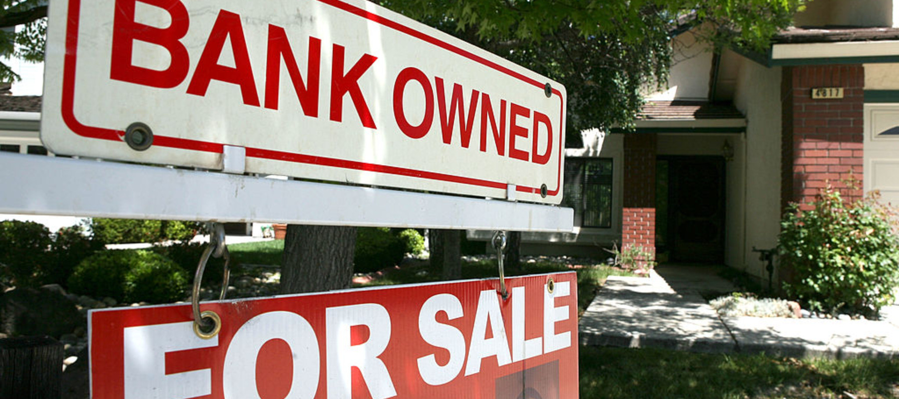 A bank owned for sale sign is posted in front of a foreclosed home May 7, 2009
