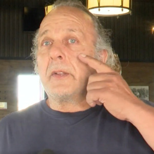 Man being interviewed, picture of winery