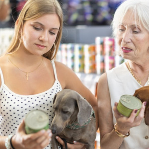 Grown adult child and mother compare prices on dog food