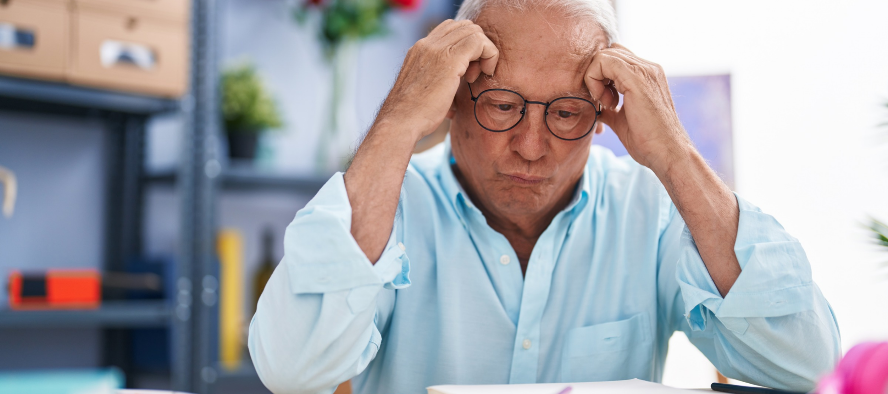 Frustrated older employee at a desk