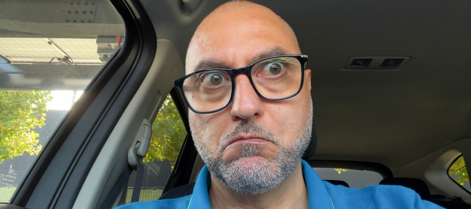 A man with an astonished expression and bulging eyes is looking directly at the camera