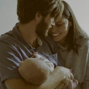 Sun Life logo on smartphone + Sepia-style photo of a young family