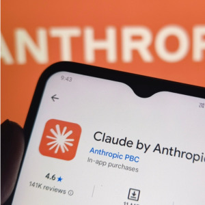 Anthropic CEO Dario Amodei + Image of Claude on smartphone