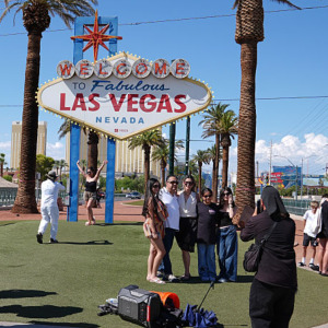 Tourists taking photo in front of Welcome to Las Vegas sign