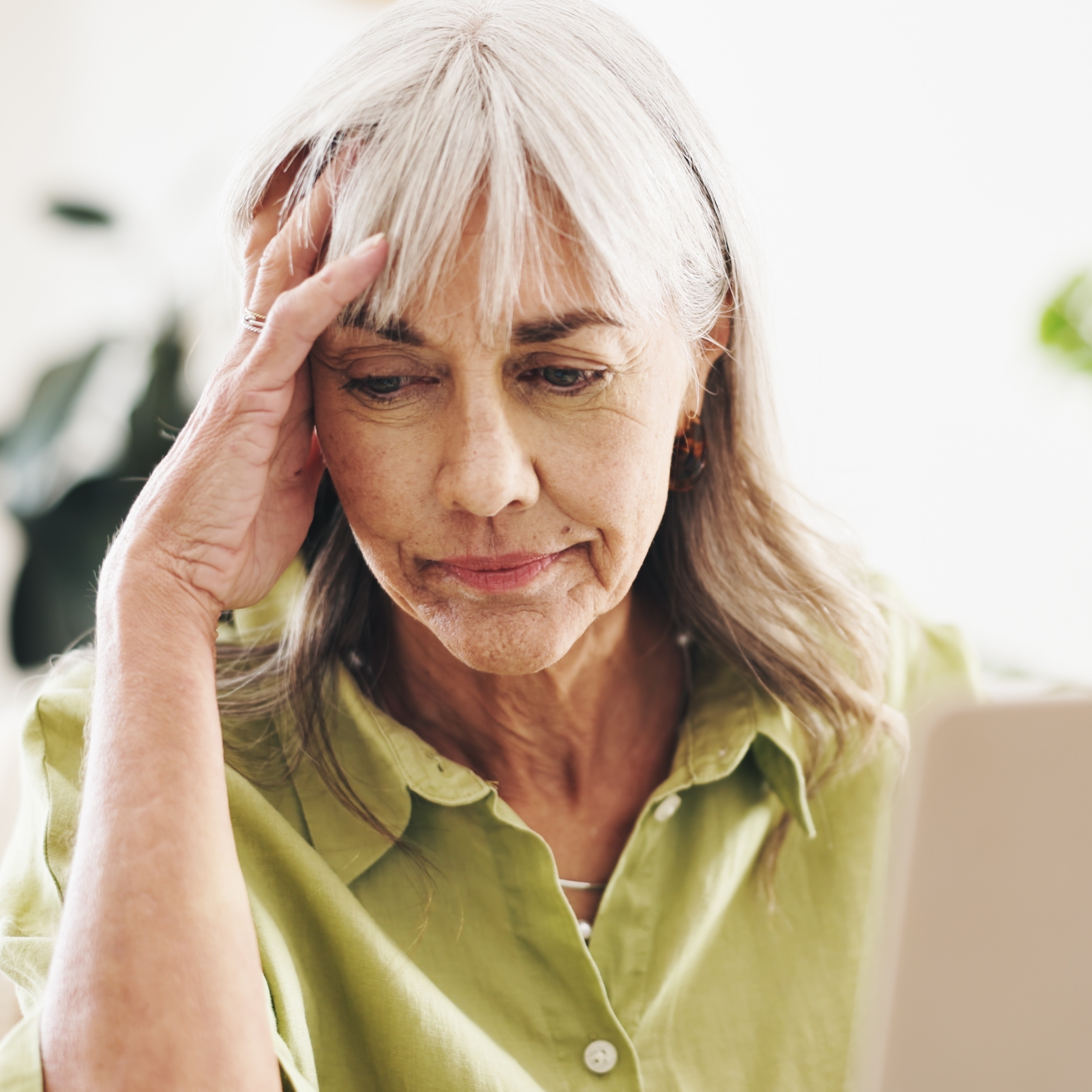 Worried older woman looking at finances