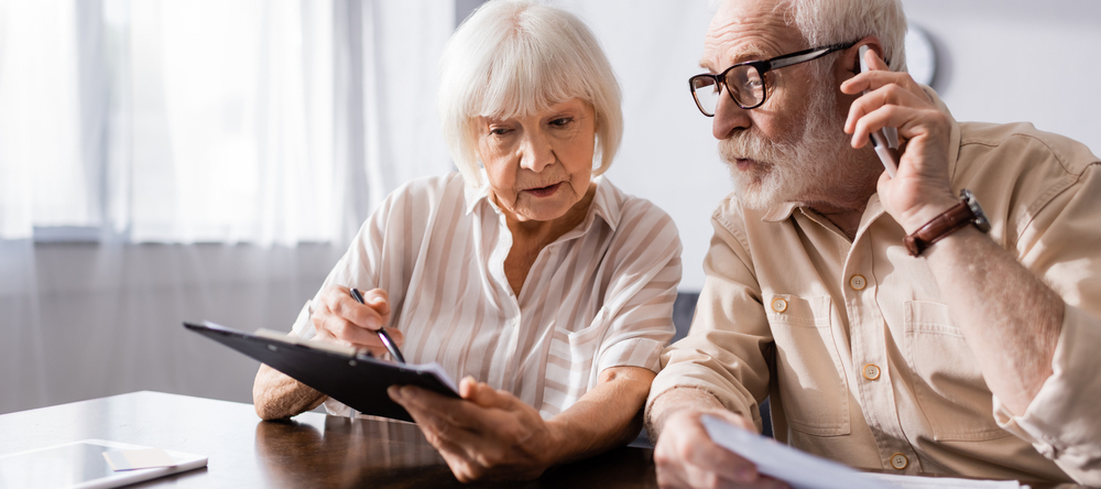 Older couple filling out financial paperwork together