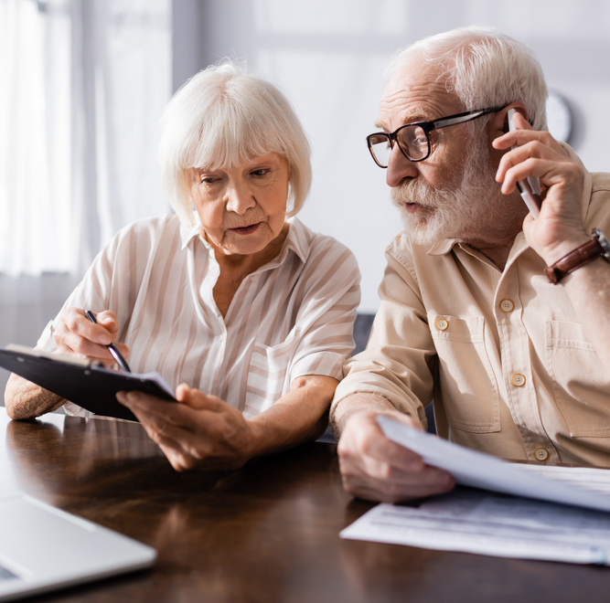 Older couple filling out financial paperwork together