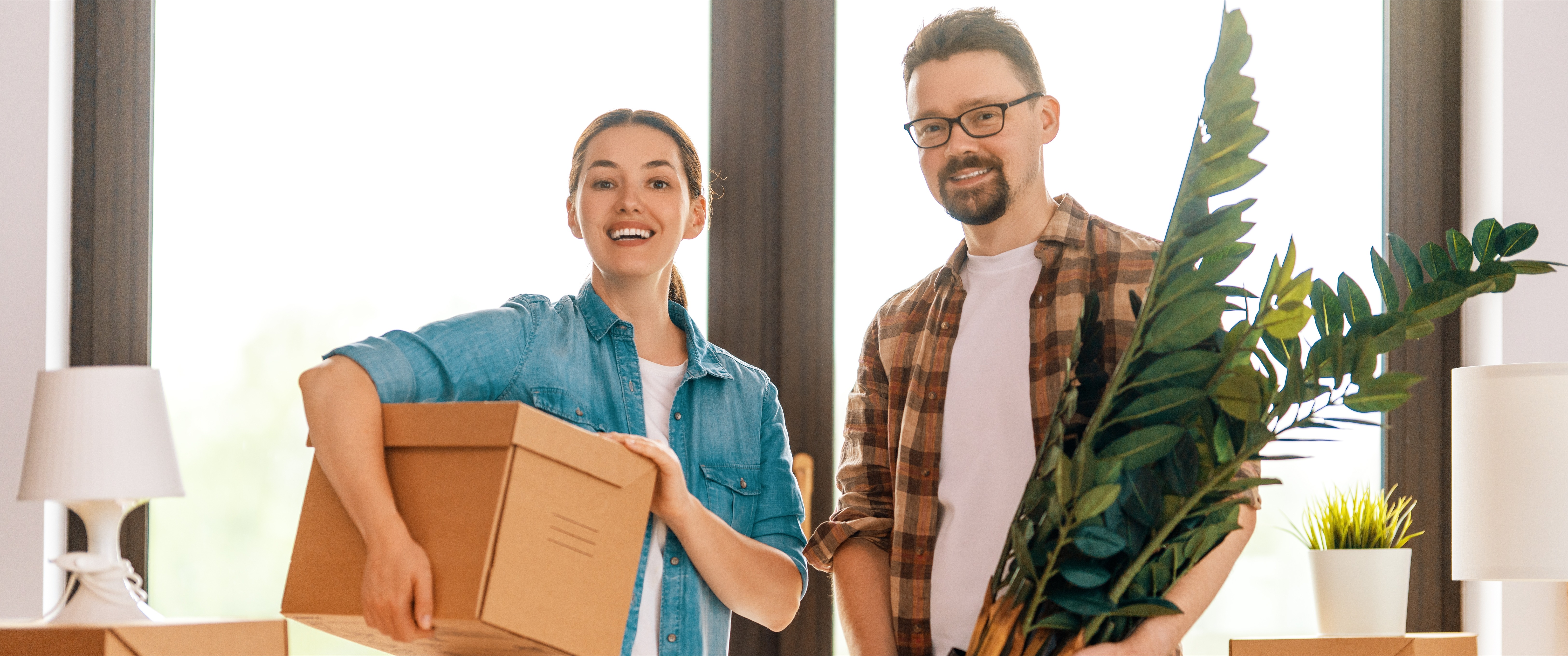 Happy young couple moving into new apartment