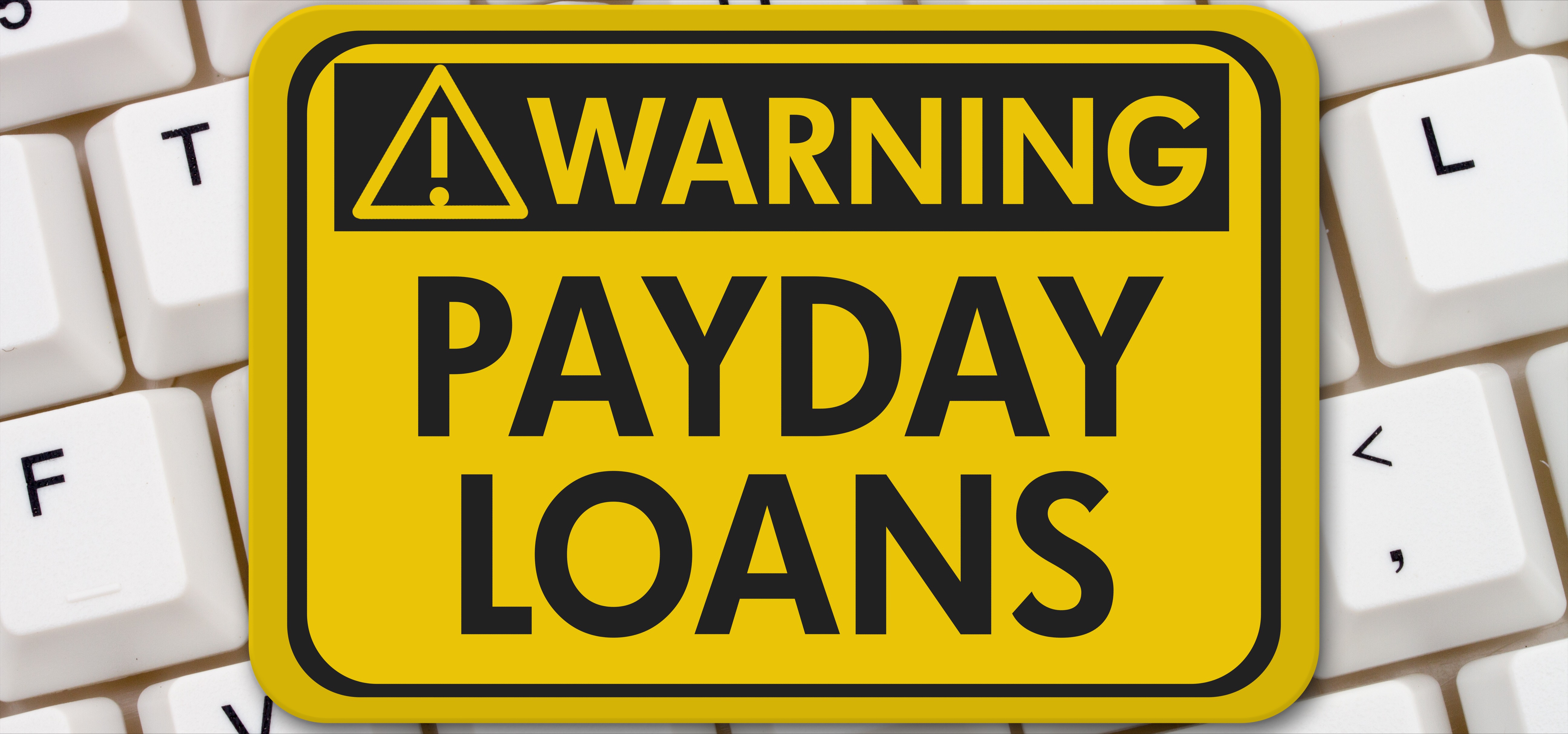 A yellow warning sign with text Payday Loans
